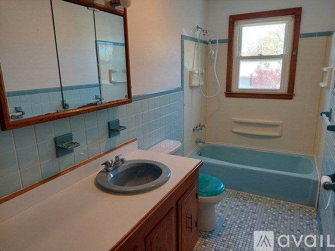 A bathroom with a sink, toilet, and bathtub.
