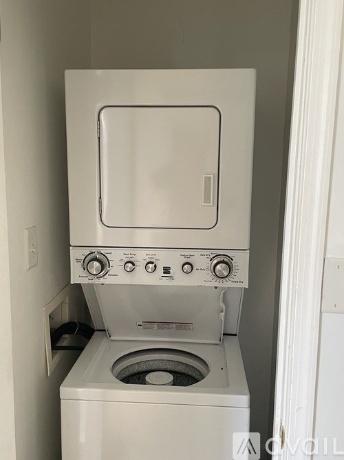 A white washing machine with a grey door and a grey control panel.