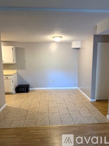 A room with a tiled floor and a white wall.