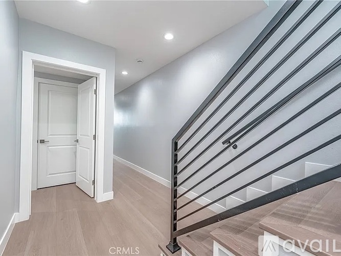 A staircase with a metal railing and wooden steps.