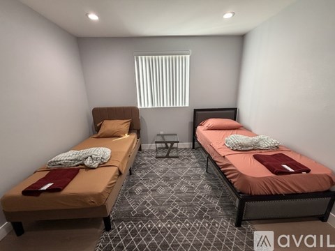 A bedroom with a bed, a wardrobe, and a mirror.