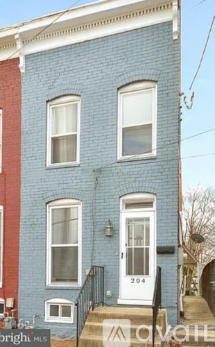 A blue and red building with the number 204 on the door.