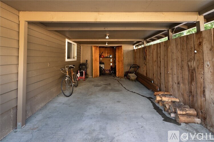 A garage with a bicycle and a fire extinguisher.