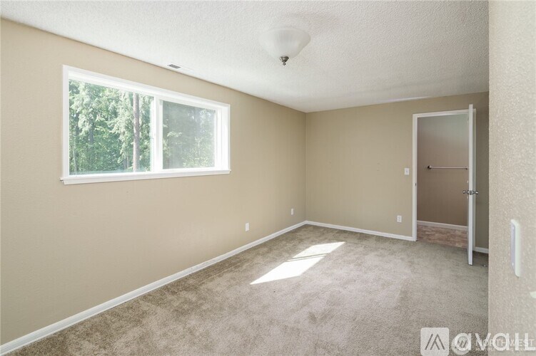 A room with a window and a door.