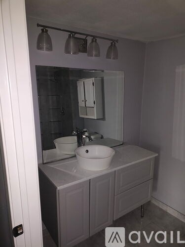 A bathroom with a sink and a mirror.