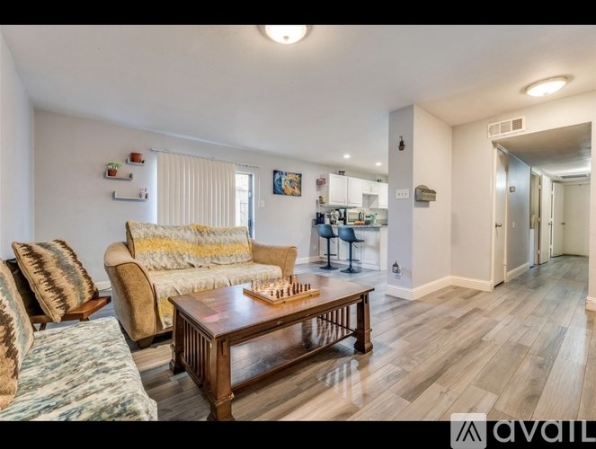 A living room with a couch, chair, and coffee table.