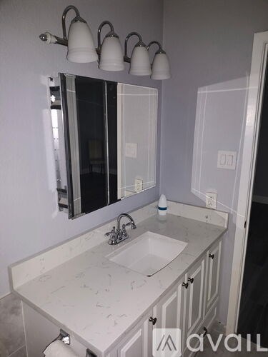 A bathroom with a sink and mirror.