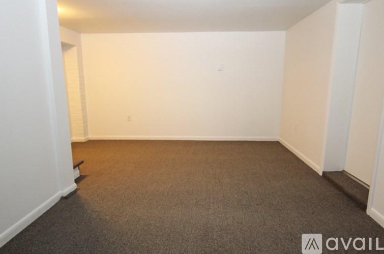 A room with carpeted floor and white walls.
