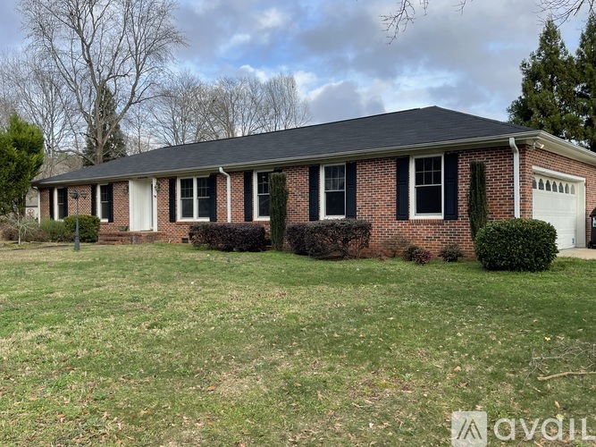 A house with a brick facade and a white garage door.