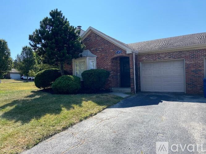 A house with a garage and a driveway in front.