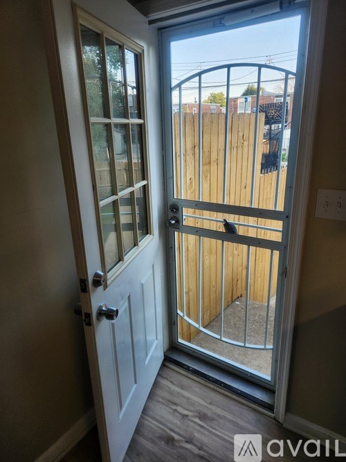 A white door with a glass window and a metal handle.