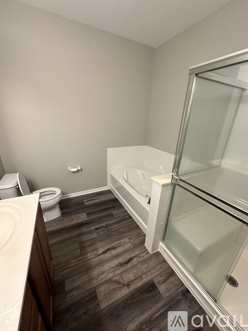 A bathroom with a toilet, sink, and bathtub.