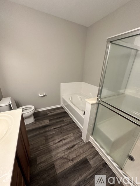A bathroom with a toilet, sink, and bathtub.