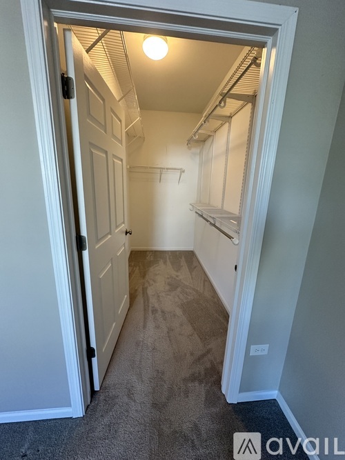 A small, empty room with a door open to a hallway.