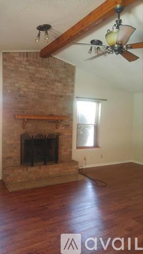 A room with a fireplace and a fan.