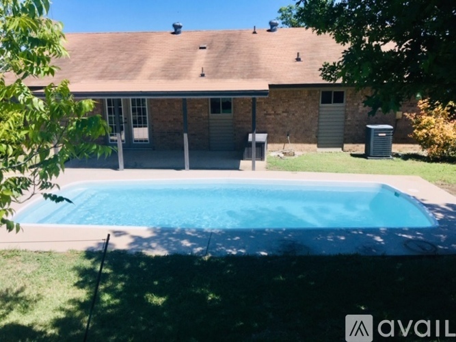 A house with a pool in the backyard.