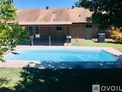 A house with a pool in the backyard.