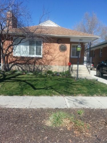 A house with a brown brick exterior and a white window.