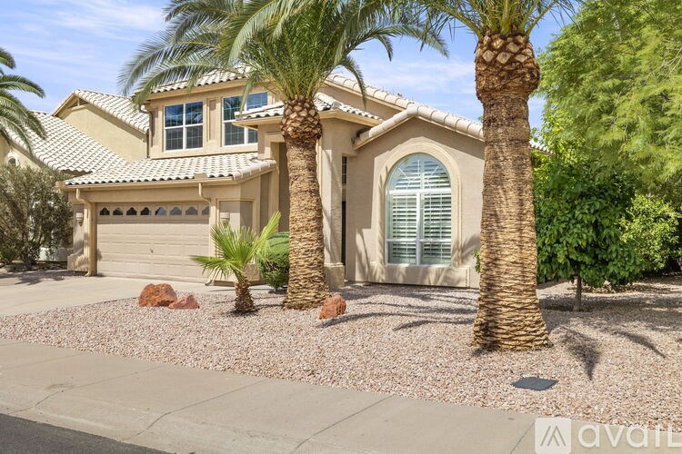 A house with a palm tree in front of it.