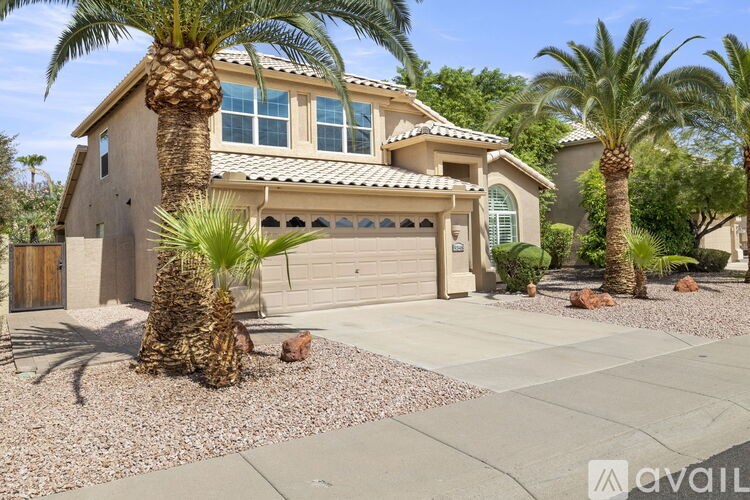 A house with a palm tree in front of it.