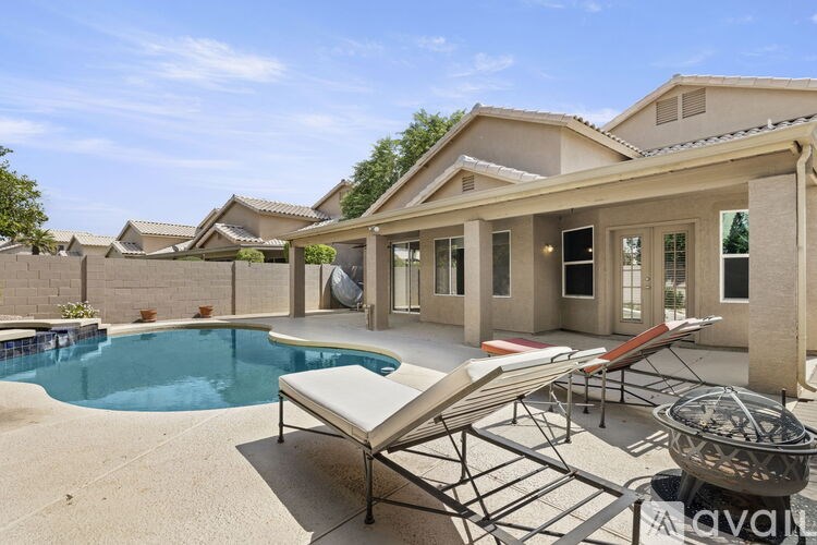 A house with a pool and a patio area.