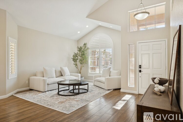 A living room with a white sofa set and a coffee table.