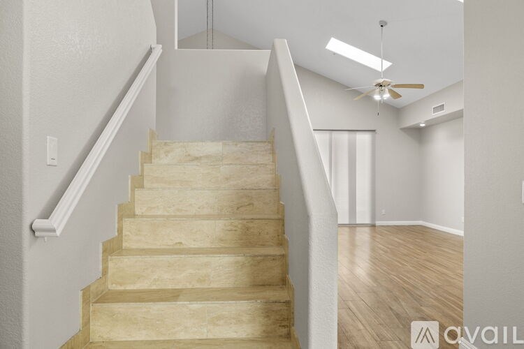 A wooden staircase with a white railing.