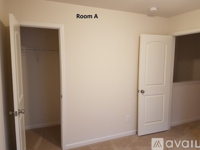 A room with a door and a wall with a window.