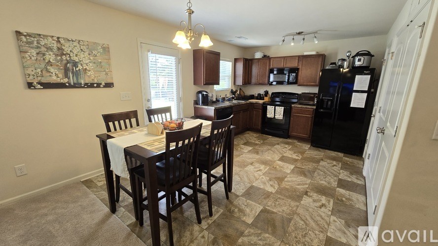 A kitchen with a table and chairs in the middle of the room.