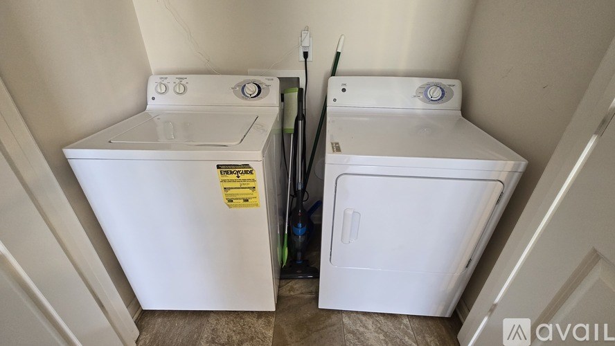 A white washing machine and dryer in a small room.