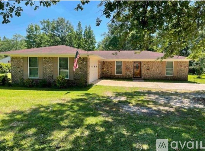 A house with a flag on the front lawn.