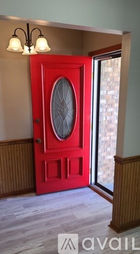 A red door with a glass window in the middle.