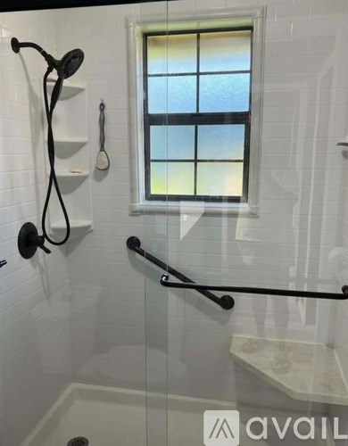 A bathroom with a window and a shower.