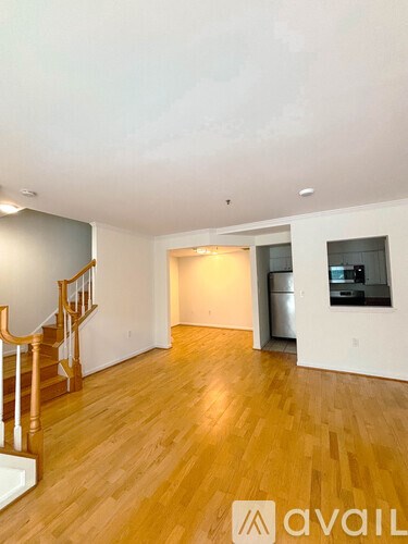 A room with wooden floors and a staircase.