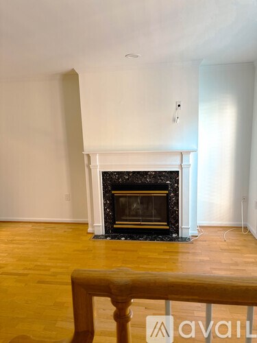 A room with a fireplace and wooden floors.