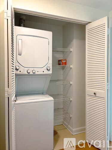 A white refrigerator with its door open in a kitchen.