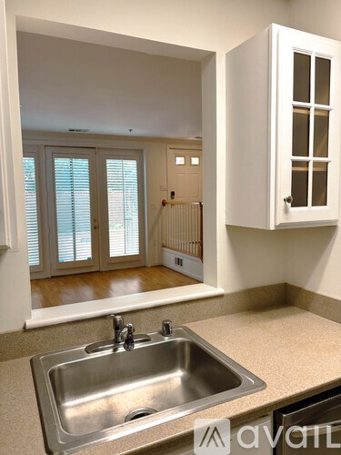 A kitchen with a sink and a cabinet.