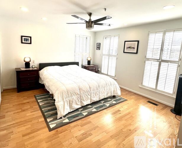 A living room with a staircase and a dining table.