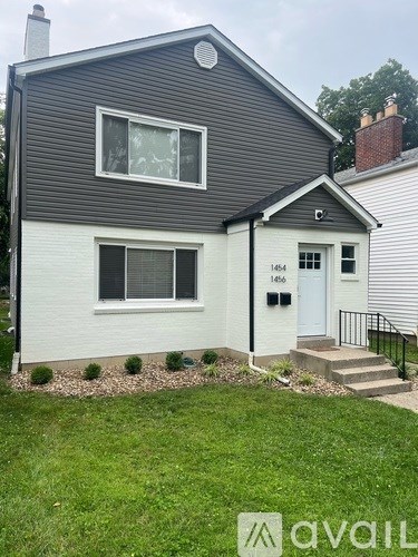 A house with a grey roof and a white door with the number 1464 on it.