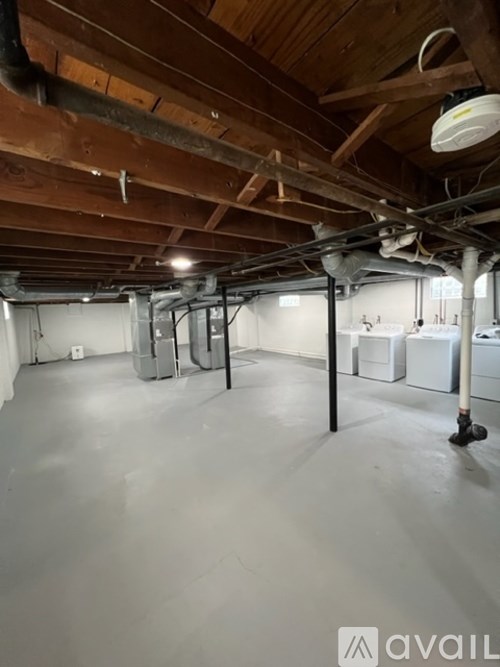 A large empty room with wooden ceiling and white walls.