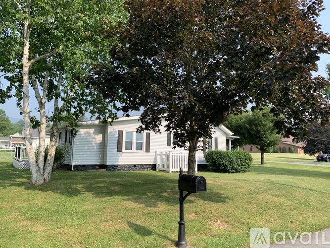 A house with a tree in front of it.