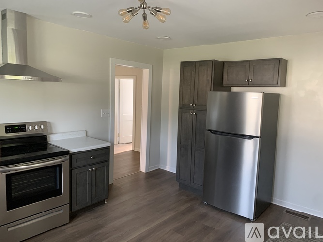 A kitchen with a stainless steel refrigerator and oven.