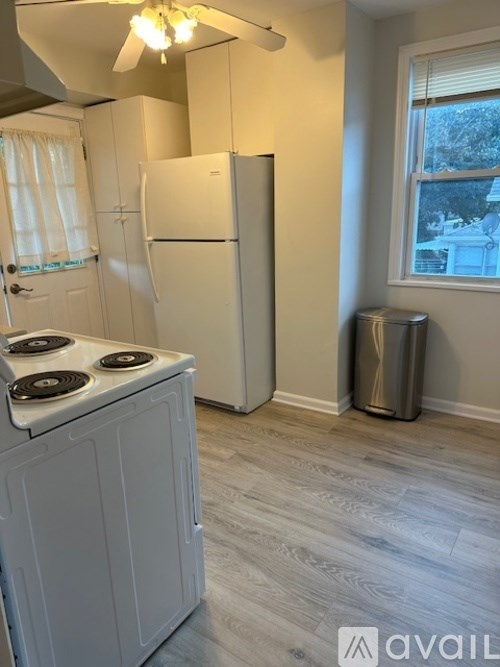 A kitchen with a white fridge and a white stove top.