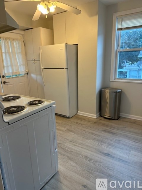 A kitchen with a white fridge and a white stove top.