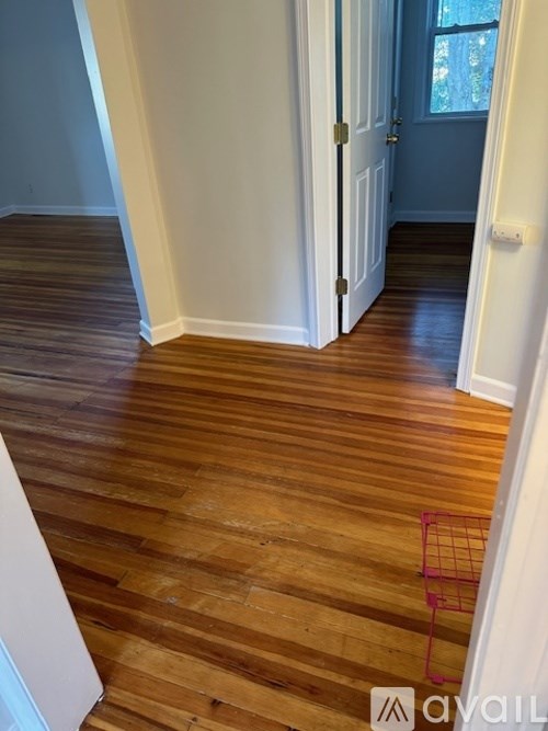 A room with wooden floors and a white door.