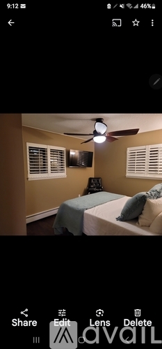 A bedroom with a bed and a ceiling fan.