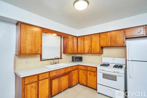 A kitchen with wooden cabinets and white appliances.