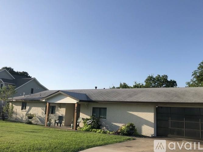 A house with a garage and a driveway in front.