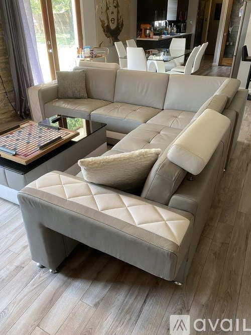 A modern living room with a large sectional sofa and a coffee table.