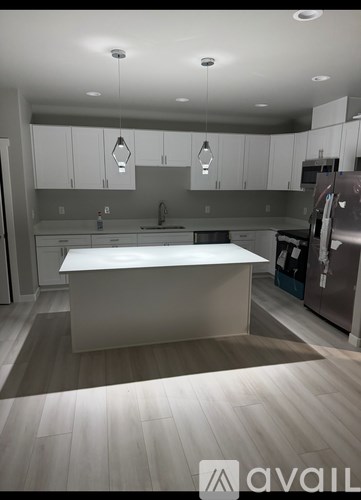 A modern kitchen with a large island in the center.